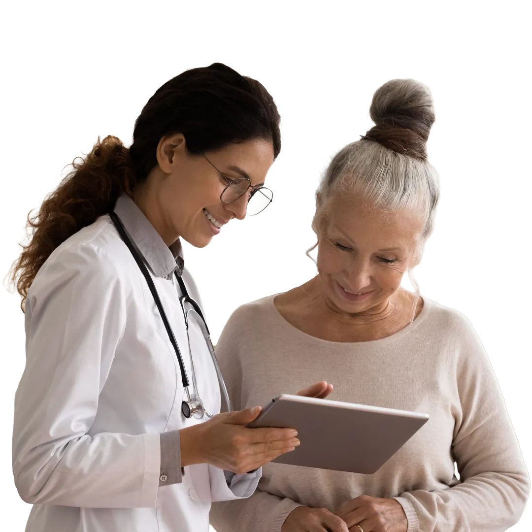 Female provider in scrubs handing a pen to a patient to sign a clipboard in a clinical consultation.