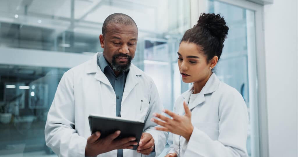 Diversity, results or doctors with tablet, planning or surgeon reading health treatment in hospital. Meeting, research team or online medical advice with clinic app for web consultation or diagnosis.