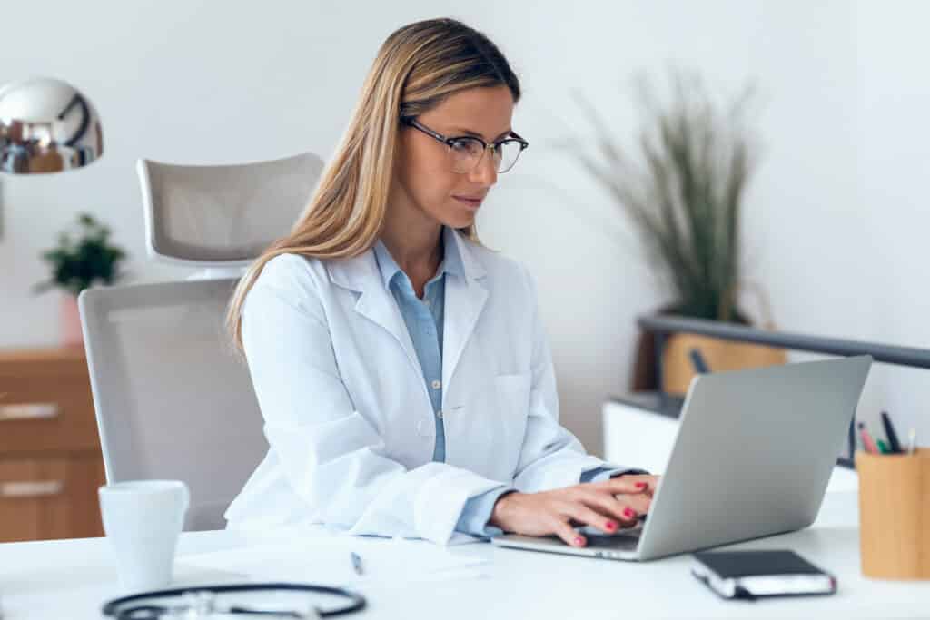 mature; doctor; online; medical; health care; worker; computer; health; hospital; using; consultation; desktop; serious; woman; female; looking; medicine; pc; technology; adult; clinical; coat; confident; consulting; diagnose; expertise; internet; lifestyle; office; person; professional; occupation; specialist; stethoscope; working; writing; woman; eyeglasses; consultation; care; successful; job; social distance; covid19; new normality; pandemic