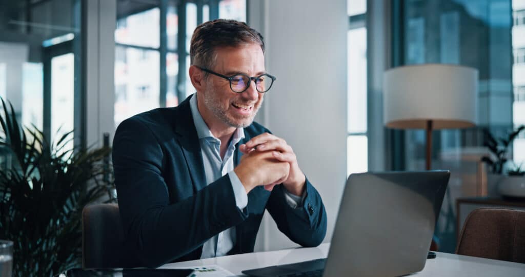 Broker, smile and mature businessman on laptop for finance, tax research and debt management. Investment banker, happy or advisor with technology for good news, financial account and report update.