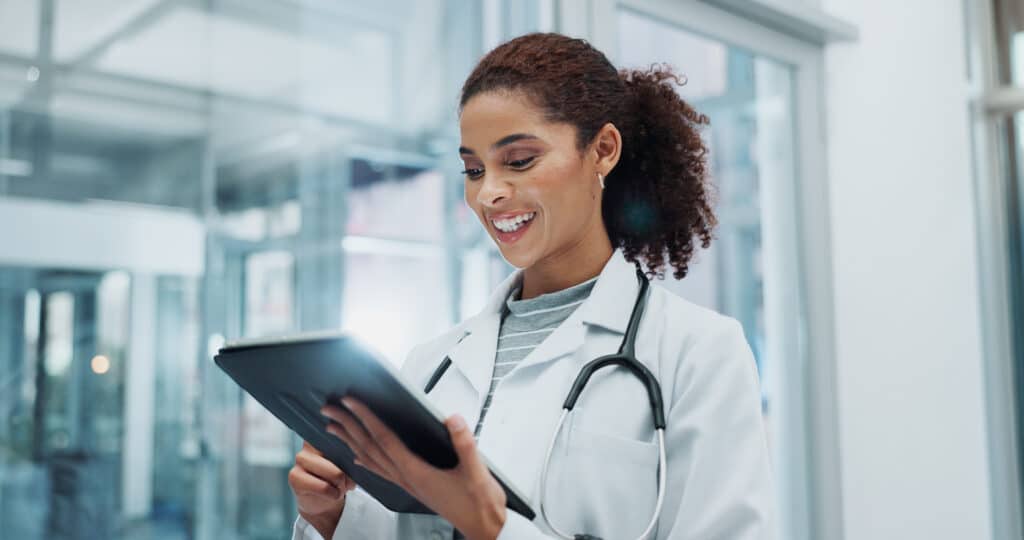 Tablet, woman and doctor with telehealth, research and wellness support at hospital with tech. Digital, smile and online medical advice with clinic app for planning and web results for consultation.