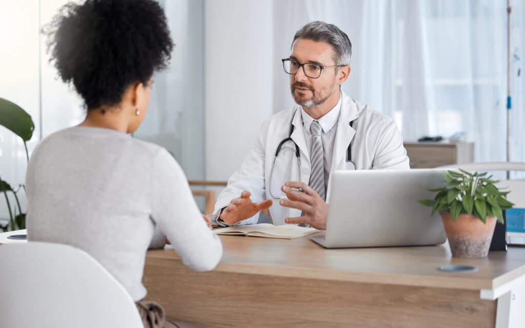 Doctor and patient discussing treatment plan using EHR