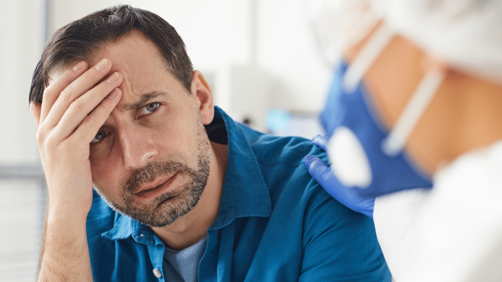 Confused man looking at doctor