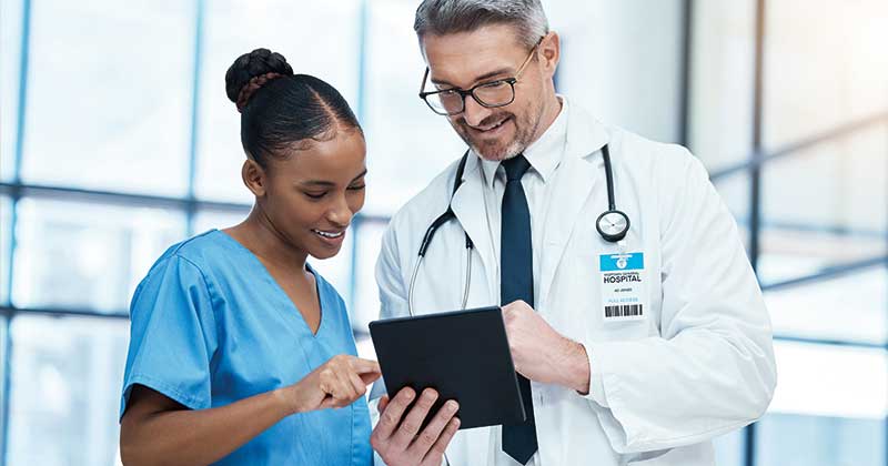 Doctor reviewing real-time patient data on a tablet