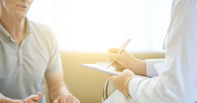 Hospital staff interacting with a patient during consultation