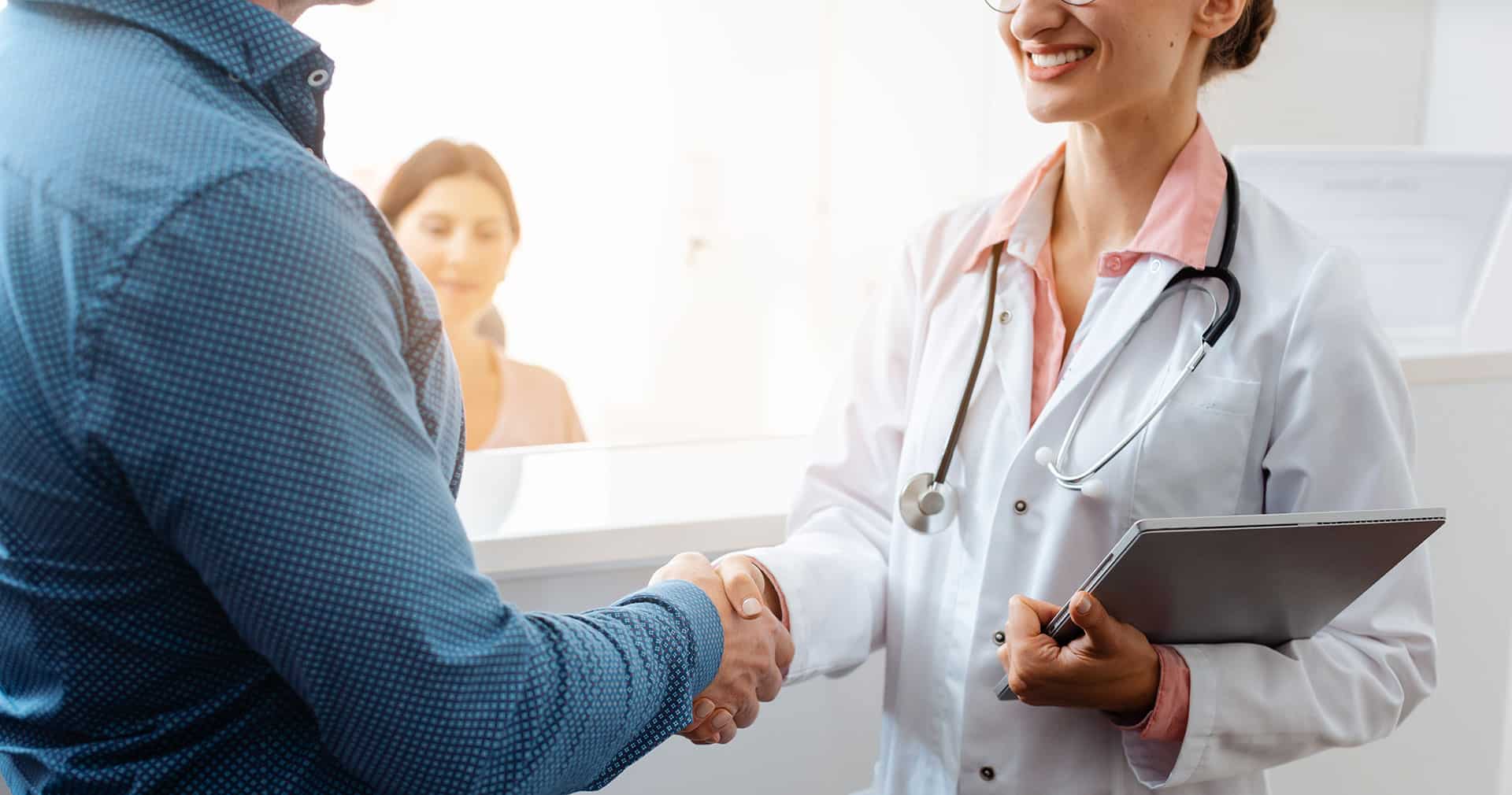 Healthcare provider reviewing patient information on a computer screen.