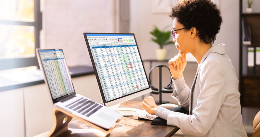 Doctor reviewing outdated medical billing software on a computer