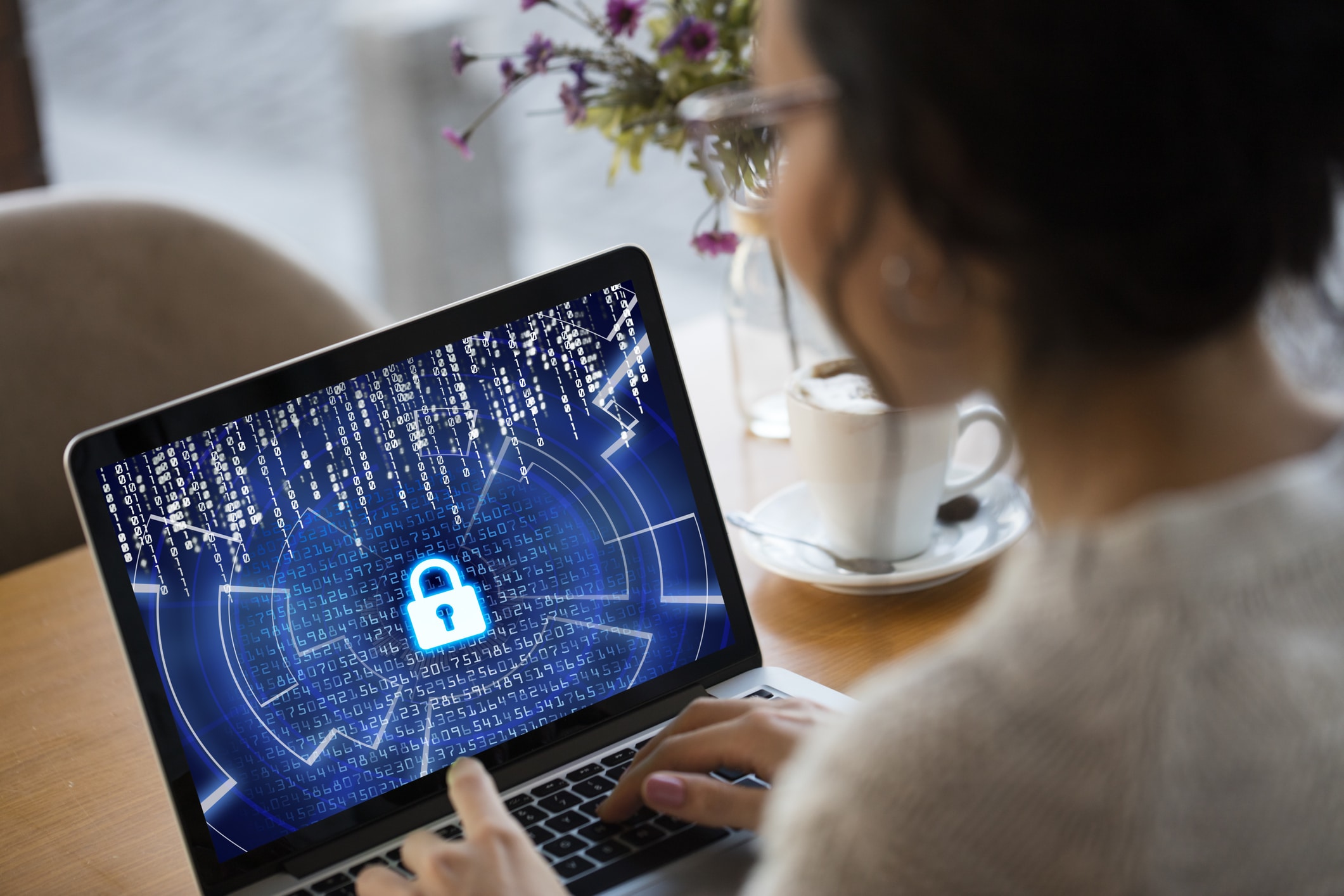 Women typing on laptop with secure icon on screen