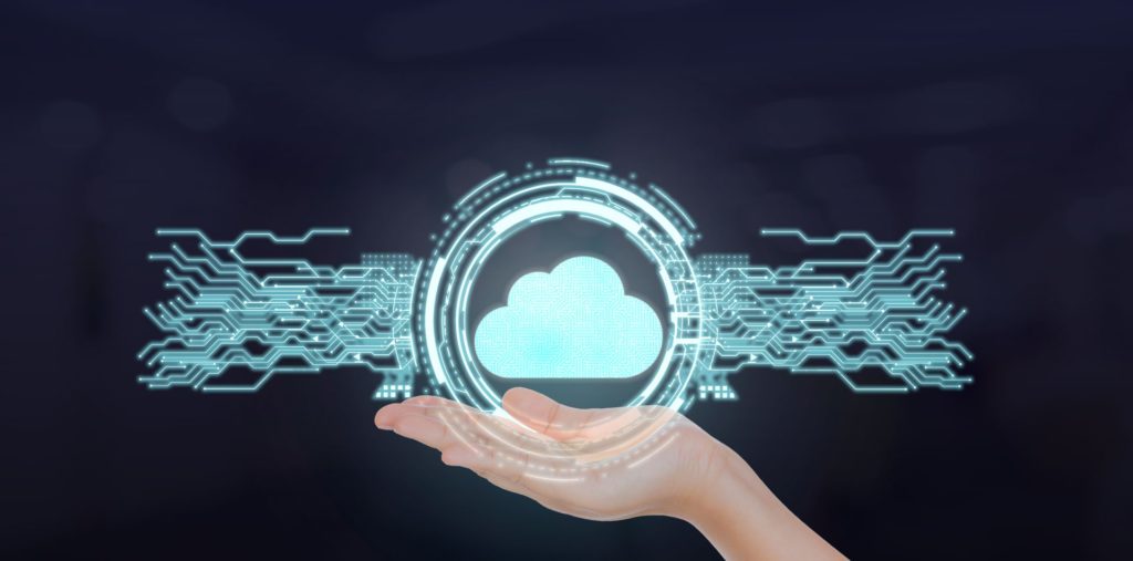 Hand holding illustration of cloud surrounded by circuit lines