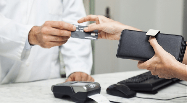 Women handing credit card over for payment