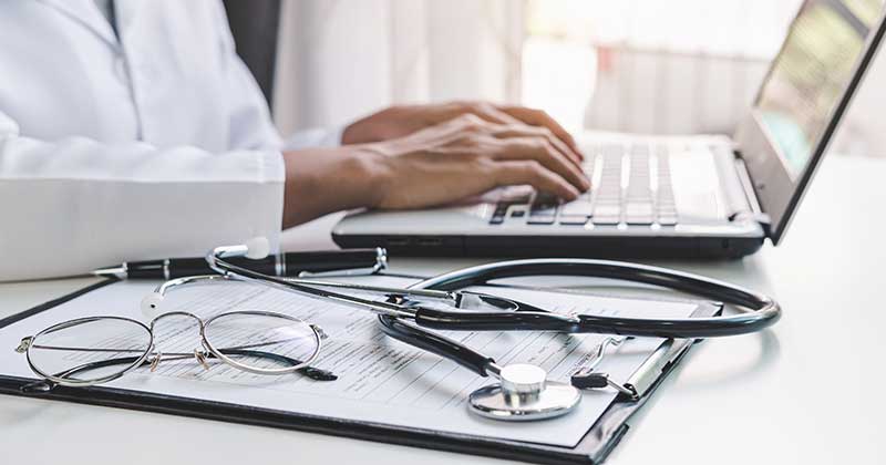 Healthcare administrator using practice management software