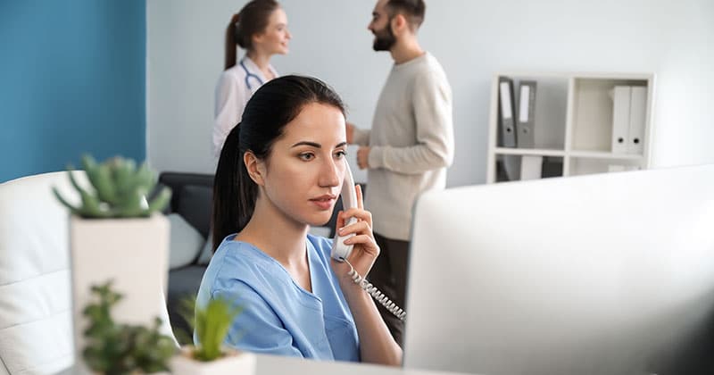 Medical staff scheduling appointments with practice management software.