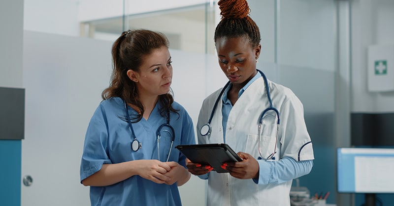 Healthcare provider using software with highlighted features for managing practice