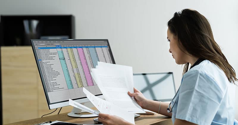 Doctor reviewing medical health billing sheets. Patient medical billing.