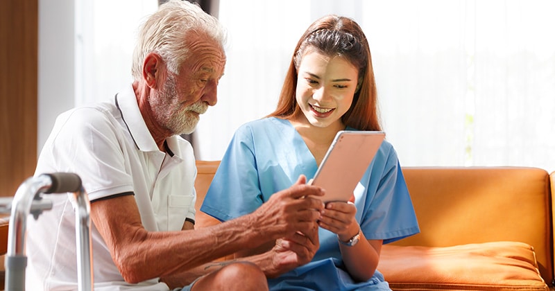 Patient using digital intake form on a tablet during check-in
