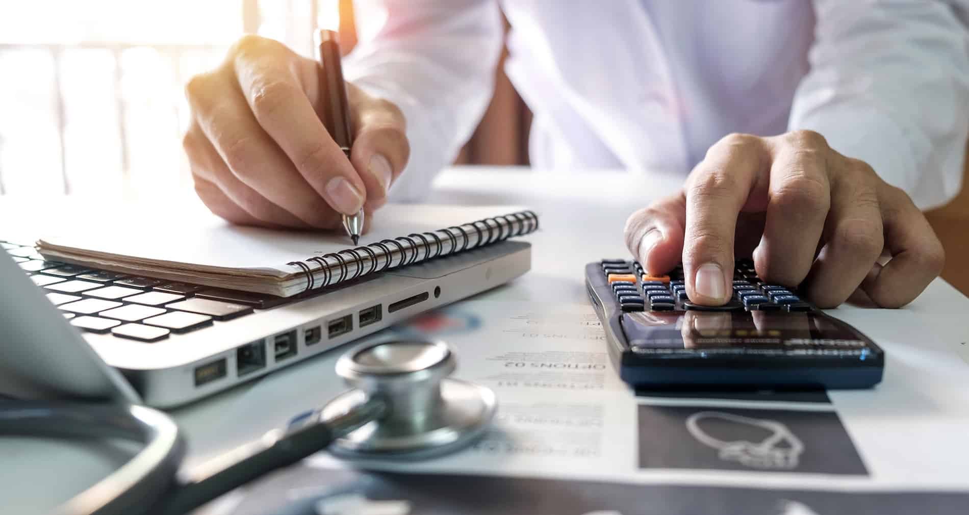 Medical staff managing billing processes using specialized software.