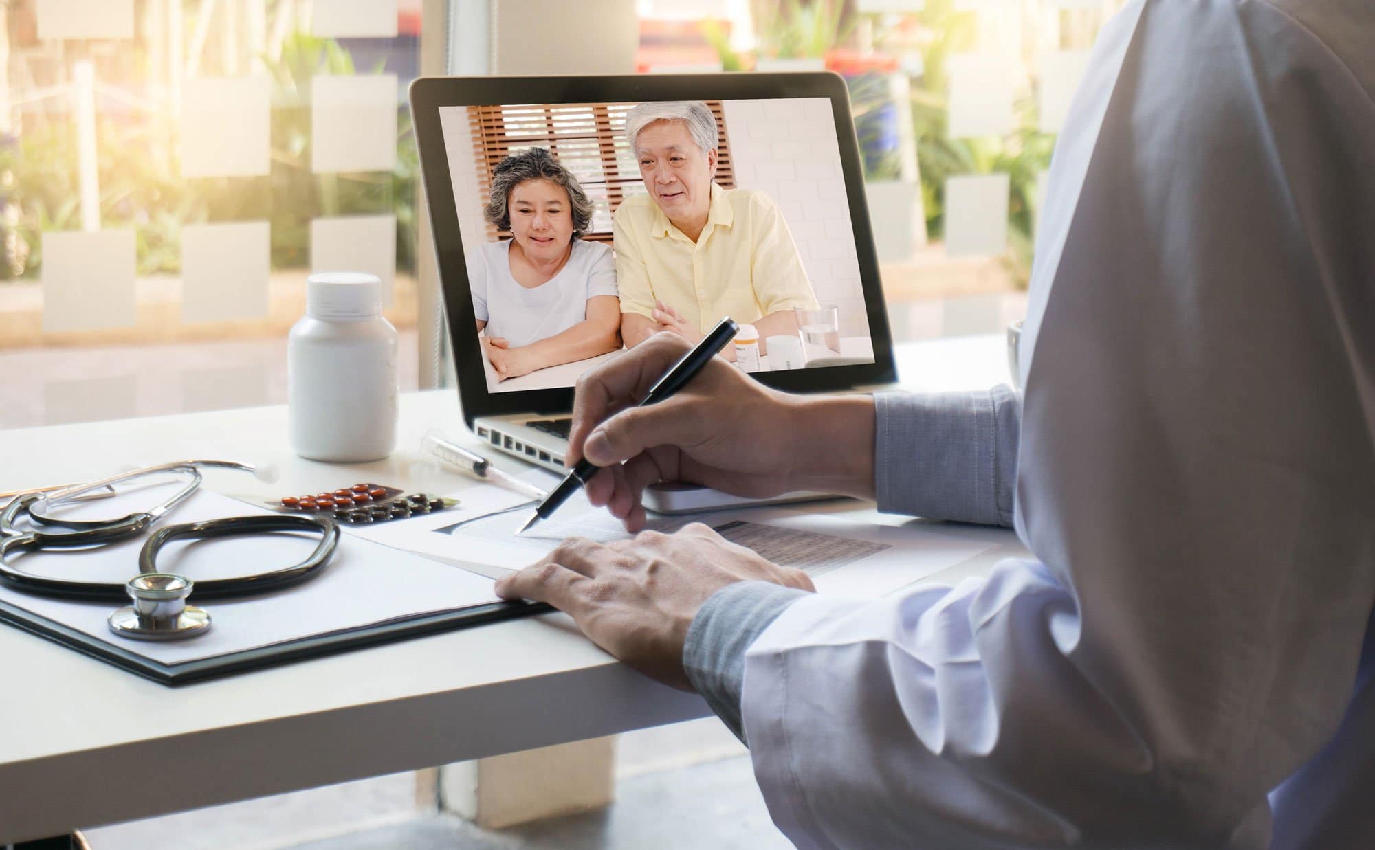 Doctor doing a telehealth visit with an elderly couple.