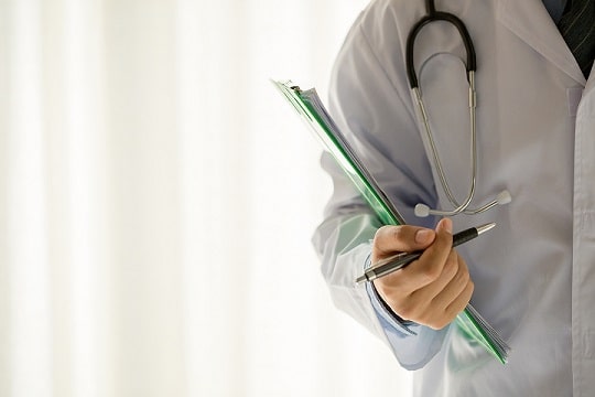 Physician holding paper in right hand. Medicine and health care concept.