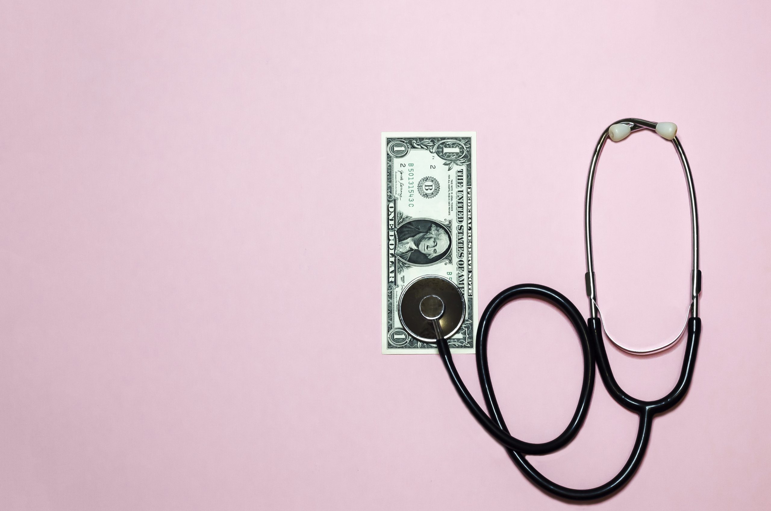 Stethoscope and dollar bill.